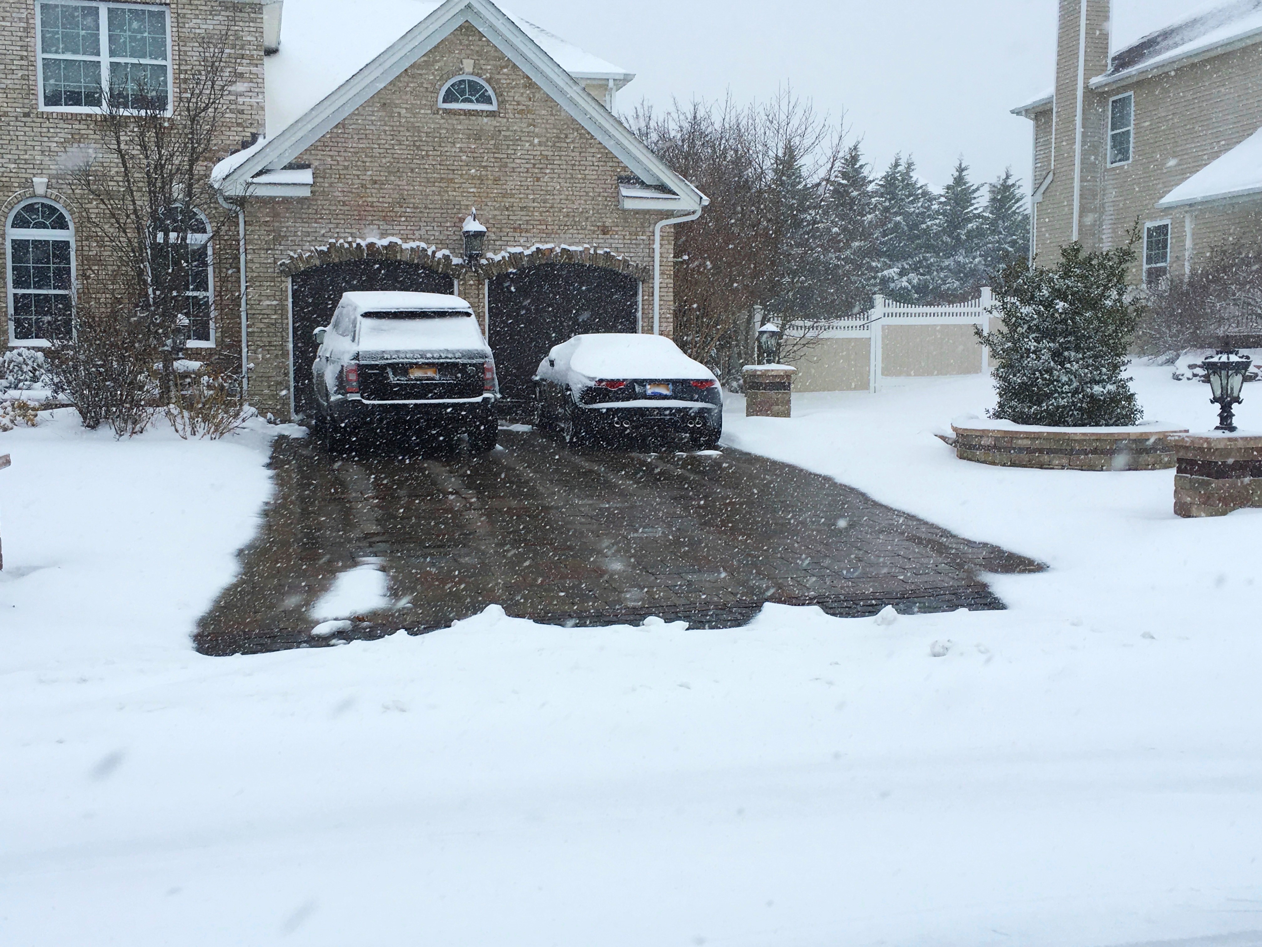a heated driveway operating in the middle of snow to melt ice and snow